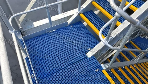 Blue grating platform with yellow-nosed stairs