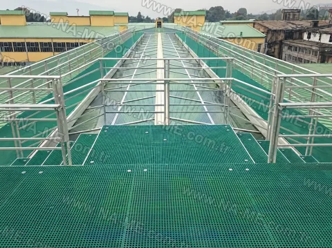 Green walkway with a rail around a roof skylight