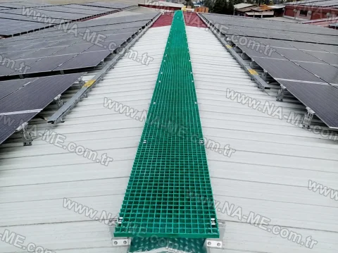 Green maintenance walkway between rooftop solar panels