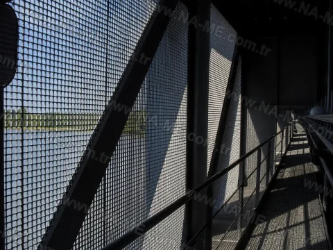 Service walkway behind a perforated facade screen