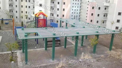 Green grating shade structure in a playground