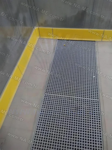 Floor channel grating in a safety-striped indoor area