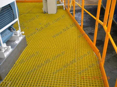 Yellow platform with an orange rail beside motors