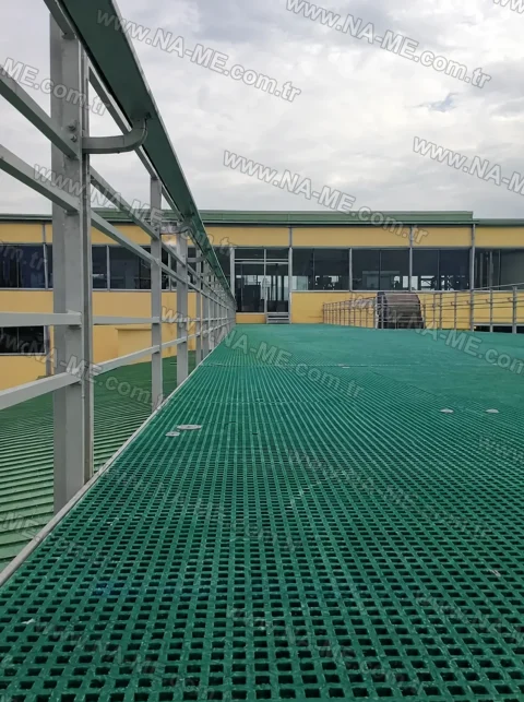 Wide green walkway platform on a factory roof