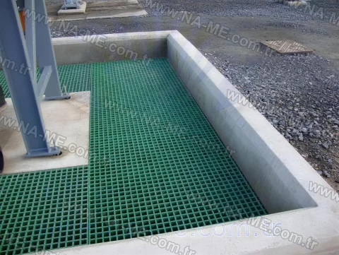 Green grating cover over a concrete pit