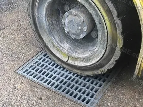 Trench grating under a heavy equipment wheel