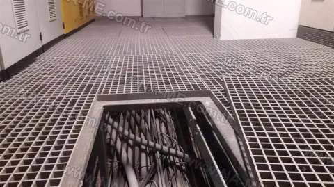 Hinged grating cover over a cable channel