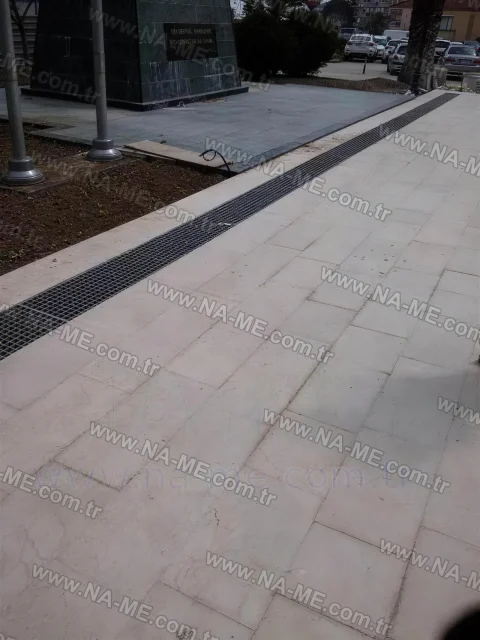 Trench grating on a sidewalk in front of a building
