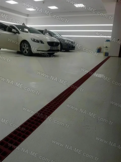 Red trench grating in a covered vehicle delivery area