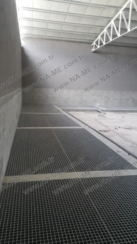 Wide grating floor inside a concrete tank