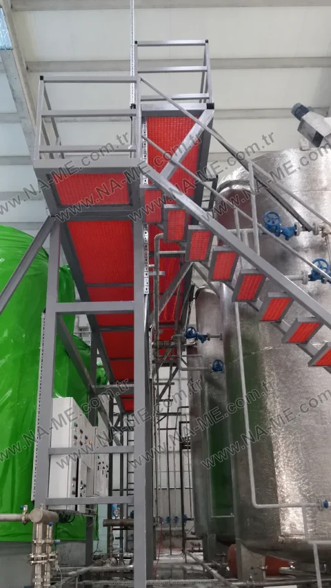 Red stair treads beside a process tank