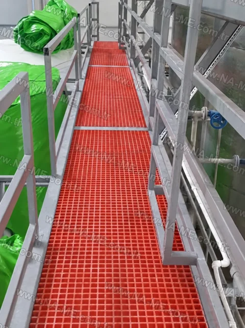 Red FRP walkway beside a process tank