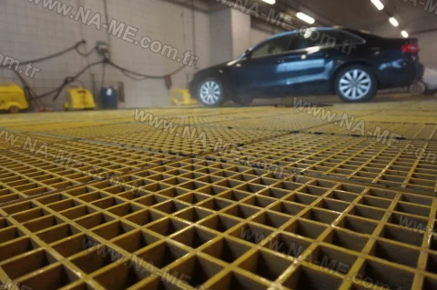 Yellow grating flooring in a vehicle wash bay