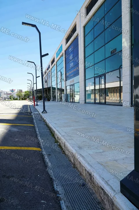 Drainage line along a building facade at a parking entrance