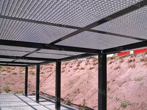 Underside view of a grating-panel pergola shade