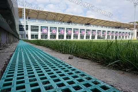 Trench grating along a stadium turf edge