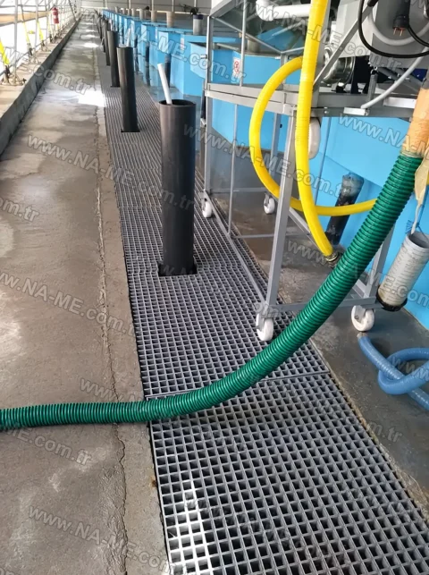 Grating walkway between pools at an aquaculture facility