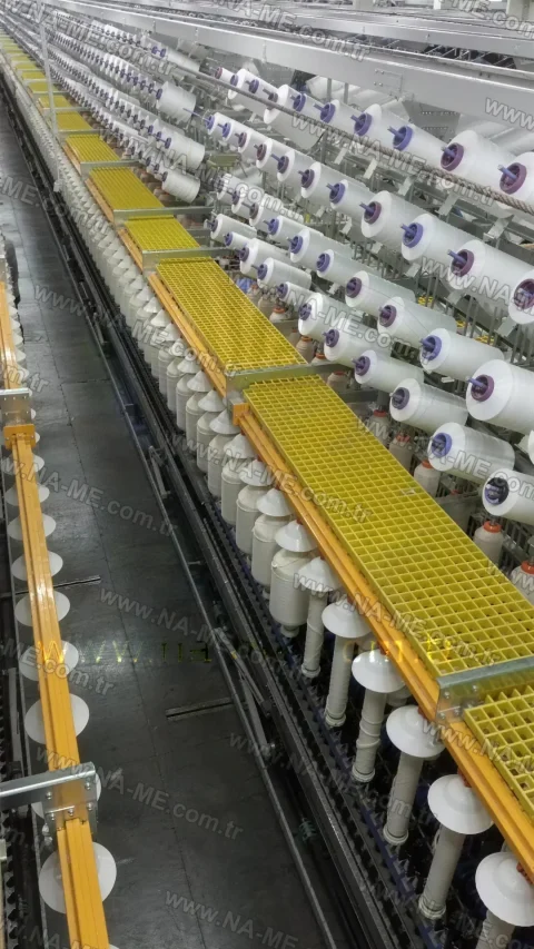 Yellow maintenance platform above textile machines