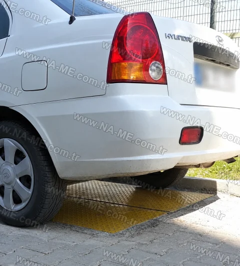 Yellow FRP cover under a car wheel