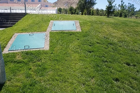 FRP covers in concrete frames on a landscaped lawn